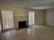 Bright living room with large windows, tile flooring, and a cozy brick fireplace at 2773 Heritage Ct, Las Vegas, NV 89121