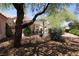 Covered patio with an outdoor dining set and beautifully landscaped backyard at 2820 Bluff Point Dr, Las Vegas, NV 89134