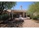 Backyard patio area with water feature for relaxation and shaded desert landscaping at 2820 Bluff Point Dr, Las Vegas, NV 89134