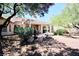 Expansive backyard featuring a covered patio, water feature, and lush landscaping at 2820 Bluff Point Dr, Las Vegas, NV 89134