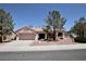 Charming single-story home featuring a two-car garage, tile roof, and desert landscaping at 2820 Bluff Point Dr, Las Vegas, NV 89134