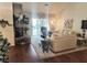 Bright living room featuring a brick fireplace, hardwood floors, and sliding glass doors to the patio at 2820 Bluff Point Dr, Las Vegas, NV 89134
