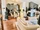 Bright living room with fireplace, chandelier, white couch and hardwood floors at 2820 Bluff Point Dr, Las Vegas, NV 89134