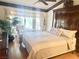 Cozy main bedroom featuring a large window, comfortable seating, and hardwood floors at 2820 Bluff Point Dr, Las Vegas, NV 89134