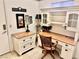 Charming home office with a wooden desk and chair and white shelving unit at 2820 Bluff Point Dr, Las Vegas, NV 89134