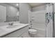 Bright bathroom featuring a single sink vanity with white marble top and tub with shower at 2870 Turnstone Ridge St, Henderson, NV 89044