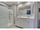 Elegant bathroom featuring double sink vanity with white marble tops, stand-up shower and tile floors at 2870 Turnstone Ridge St, Henderson, NV 89044
