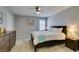 Cozy bedroom featuring neutral walls, ceiling fan and a bed with a blue throw blanket at 2870 Turnstone Ridge St, Henderson, NV 89044