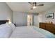 Comfortable bedroom with a ceiling fan, a queen-sized bed, and a wooden dresser at 2870 Turnstone Ridge St, Henderson, NV 89044