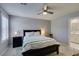 Inviting bedroom with a ceiling fan, a queen-sized bed, and an ensuite bathroom at 2870 Turnstone Ridge St, Henderson, NV 89044