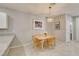 Bright dining area adjacent to the kitchen with natural wood table and stylish light fixture at 2870 Turnstone Ridge St, Henderson, NV 89044