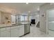 Bright kitchen features stainless appliances, stone counters, and white cabinets at 2870 Turnstone Ridge St, Henderson, NV 89044