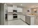 Bright kitchen features stainless appliances, stone counters, and white cabinets at 2870 Turnstone Ridge St, Henderson, NV 89044