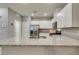 Bright kitchen features stainless appliances, stone counters, and white cabinets at 2870 Turnstone Ridge St, Henderson, NV 89044