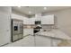 Bright kitchen features stainless appliances, stone counters, and white cabinets at 2870 Turnstone Ridge St, Henderson, NV 89044