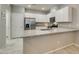 Bright kitchen features stainless appliances, stone counters, and white cabinets at 2870 Turnstone Ridge St, Henderson, NV 89044