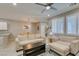 Bright living room featuring neutral decor, ceiling fan, large windows, and comfortable seating at 2870 Turnstone Ridge St, Henderson, NV 89044