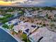 Beautiful aerial view of a neighborhood featuring well-maintained homes with colorful tile roofs at sunset at 3020 Via Venezia, Henderson, NV 89052