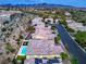 Expansive aerial view of a lovely home featuring solar panels and a backyard pool in a verdant community at 3020 Via Venezia, Henderson, NV 89052