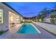 Backyard features an inviting pool, lush landscaping and a covered patio, perfect for outdoor living at 3020 Via Venezia, Henderson, NV 89052