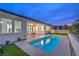 Backyard features a refreshing pool, a covered patio, and a well-maintained lawn, creating a perfect oasis at 3020 Via Venezia, Henderson, NV 89052