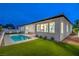 Backyard view featuring a private pool, well-maintained artificial turf, and a covered patio at 3020 Via Venezia, Henderson, NV 89052