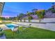 Beautiful backyard features a sparkling pool, artificial grass, and serene hillside views making for relaxed lifestyle at 3020 Via Venezia, Henderson, NV 89052