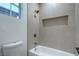 Bathroom featuring decorative tile, a shower and tub combination, and a built-in wall niche at 3020 Via Venezia, Henderson, NV 89052