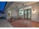 Charming covered patio with exposed brick, ceiling fans, stylish outdoor seating, perfect for relaxing at 3020 Via Venezia, Henderson, NV 89052