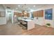 Modern kitchen featuring stainless steel appliances, a waterfall island with seating, and stylish pendant lighting at 3020 Via Venezia, Henderson, NV 89052