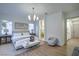Bright main bedroom showcasing hardwood floors and an ensuite bathroom at 3020 Via Venezia, Henderson, NV 89052