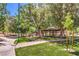 Scenic park view with a covered picnic area, walking path, playground, and lush green trees for outdoor enjoyment at 3020 Via Venezia, Henderson, NV 89052