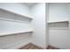 Spacious walk-in closet with wood laminate flooring, wooden rods and shelving offer ample storage at 3020 Via Venezia, Henderson, NV 89052