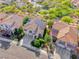 A high-angle view shows the houses in the neighborhood, their roofs, lawns and nearby greenery at 3050 Whispering Crest Dr, Henderson, NV 89052