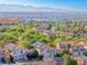 Areal view of a community surrounded by lush landscapes and mountain views at 3050 Whispering Crest Dr, Henderson, NV 89052