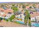 This high-angle view of the community shows its houses, swimming pools, and landscaping at 3050 Whispering Crest Dr, Henderson, NV 89052
