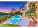 Backyard features a pool, an upper deck, comfortable seating, and palm trees at 3050 Whispering Crest Dr, Henderson, NV 89052