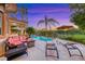 Inviting backyard with a sparkling pool, patio furniture, and well-maintained landscaping at 3050 Whispering Crest Dr, Henderson, NV 89052