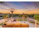 Relaxing balcony with comfortable seating and stunning views of the mountains at sunset at 3050 Whispering Crest Dr, Henderson, NV 89052