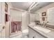 Bright bathroom featuring a shower, sink, and elegant vanity at 3050 Whispering Crest Dr, Henderson, NV 89052