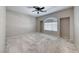 Bright, spacious bedroom featuring neutral tones, carpet, a large window, and ample natural light at 3050 Whispering Crest Dr, Henderson, NV 89052