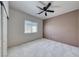 Bedroom with a ceiling fan, neutral paint, carpet, a window, and a sliding door at 3050 Whispering Crest Dr, Henderson, NV 89052