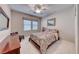 Cozy bedroom featuring neutral walls, carpet, a ceiling fan, and a window providing natural light at 3050 Whispering Crest Dr, Henderson, NV 89052