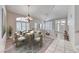 Inviting dining room featuring chandelier, decorative rug, and plantation shutters at 3050 Whispering Crest Dr, Henderson, NV 89052