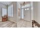 Bright entryway featuring tile and wood floors, high ceilings, and stylish window shutters at 3050 Whispering Crest Dr, Henderson, NV 89052