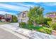 Charming stucco two-story home featuring a well-manicured front yard and a two-car garage at 3050 Whispering Crest Dr, Henderson, NV 89052