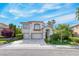 Inviting two-story home with a two-car garage and lush landscaping in a suburban neighborhood at 3050 Whispering Crest Dr, Henderson, NV 89052