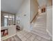 Welcoming foyer with a soaring ceiling, tile floors, staircase, and decorative entry door at 3050 Whispering Crest Dr, Henderson, NV 89052