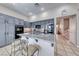 Kitchen island with granite countertops, stainless steel appliances and blue painted cabinets at 3050 Whispering Crest Dr, Henderson, NV 89052