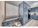 An office nook is just off the kitchen with granite countertops and blue painted cabinets at 3050 Whispering Crest Dr, Henderson, NV 89052
